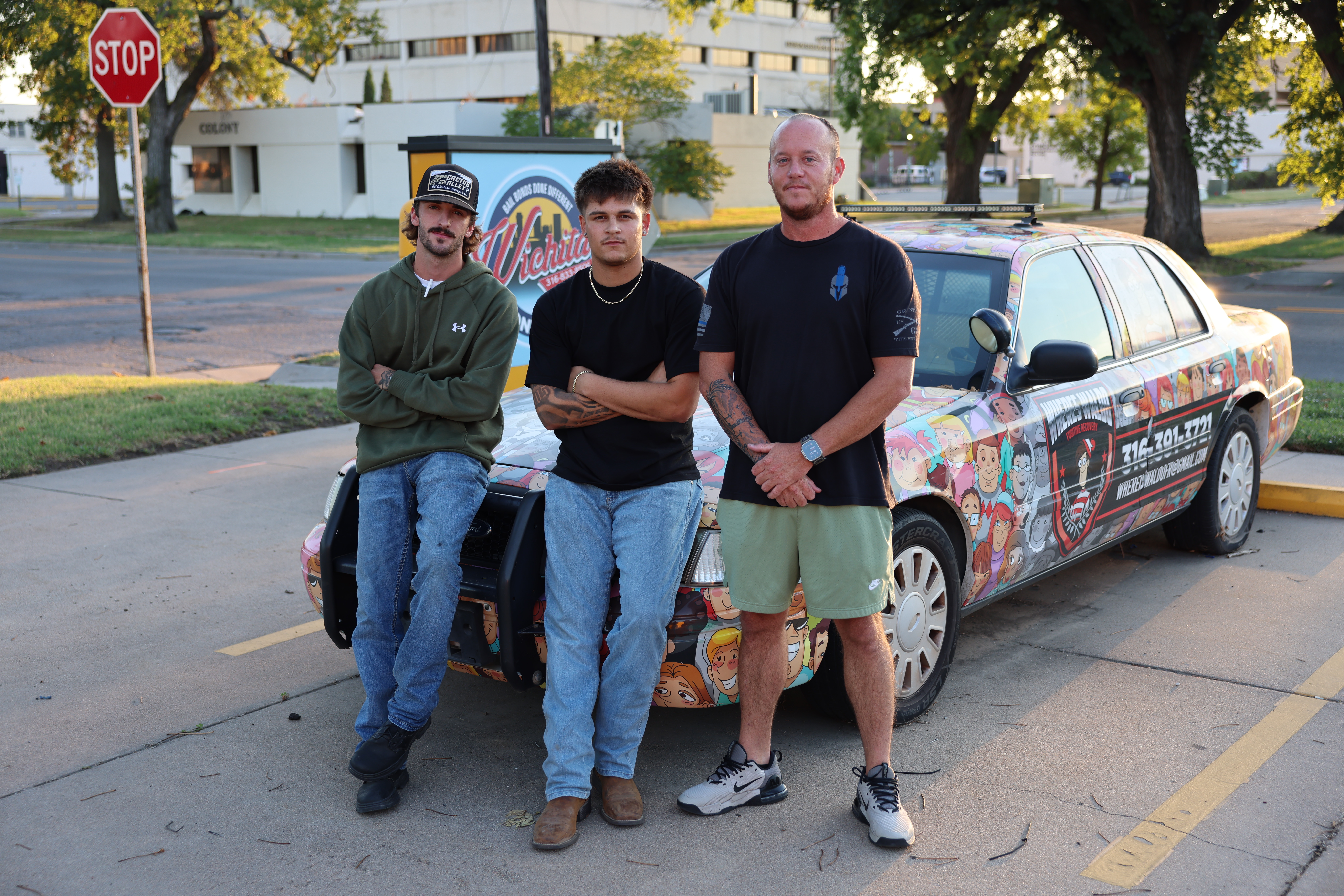 Three team members standing beside the Where’s Waldo vehicle